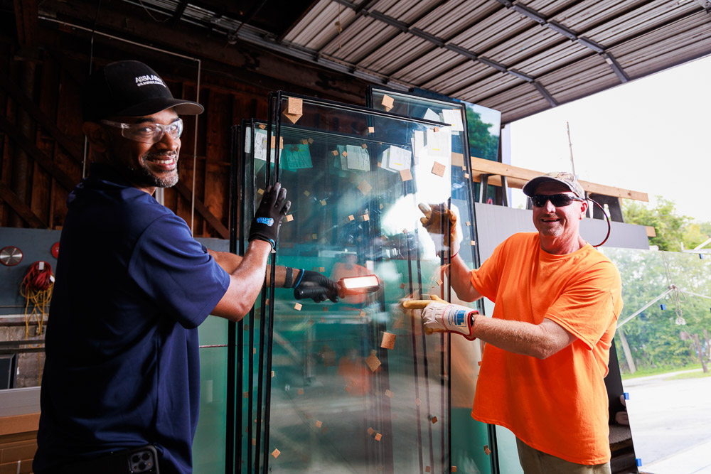 Duval Glass & Mirror team members loading glass on a job site in Jacksonville