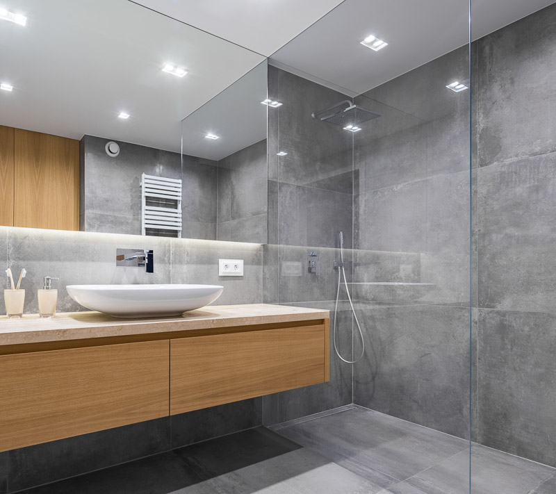Frameless glass shower enclosure installed in a finished Jacksonville bathroom