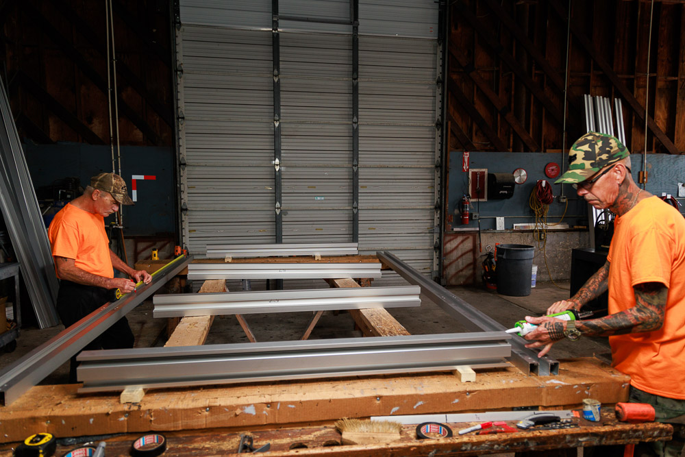 Duval Glass & Mirror crew fabricating custom-cut glass and frames in the Jacksonville shop